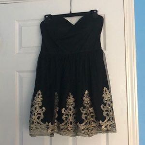 Sweetheart cut mini black dress with gold lacing